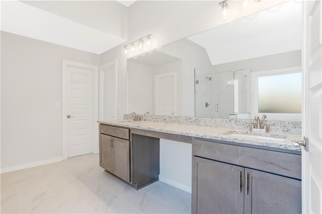 2596 Parkside Way Gainesville, GA 30507 - Photo 20 of 27 a bathroom with a granite countertop sink and a mirror