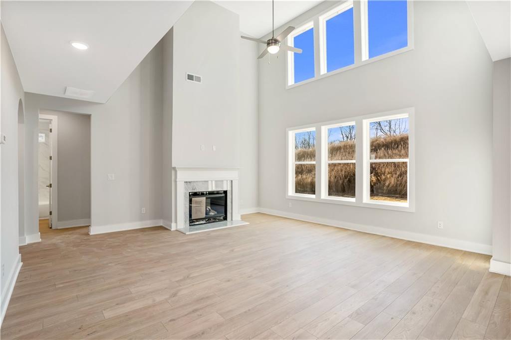 2596 Parkside Way Gainesville, GA 30507 - Photo 8 of 33 a view of an empty room with a fireplace and a window