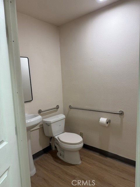 24609 Arch Street Newhall, CA 91321 - Photo 18 of 29 a white toilet sitting next to a bathroom sink