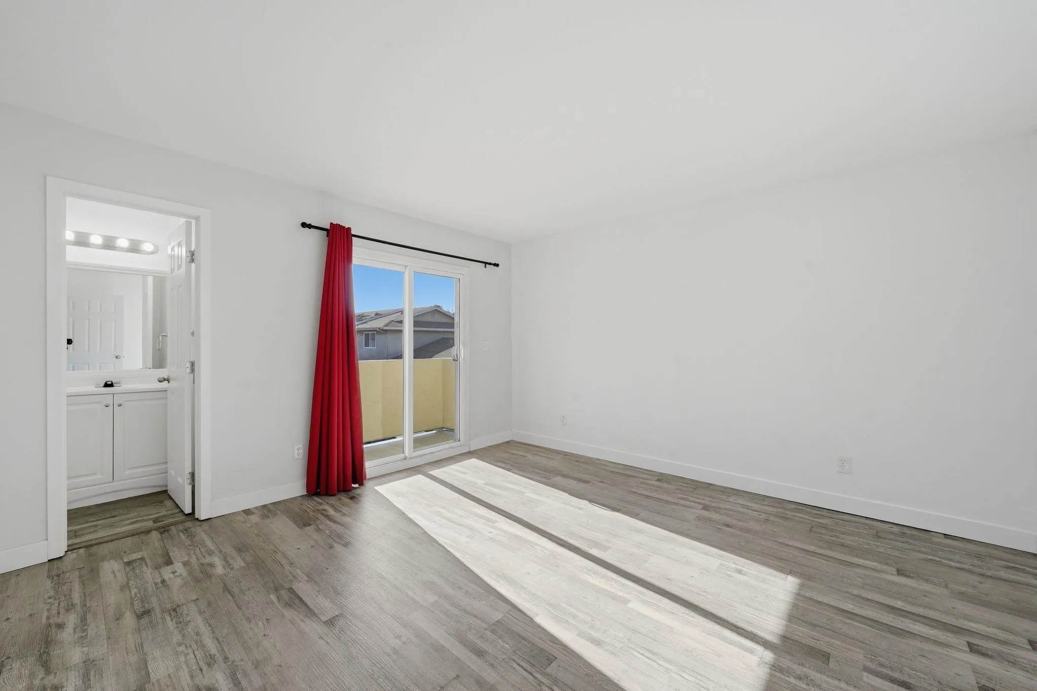 293 Sycamore Road, Unit 15 San Ysidro, CA 92173 - Photo 15 of 25 a view of an empty room with wooden floor and a window