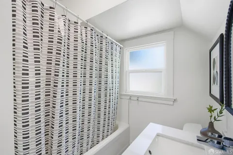 a bathroom with a toilet and a shower curtain