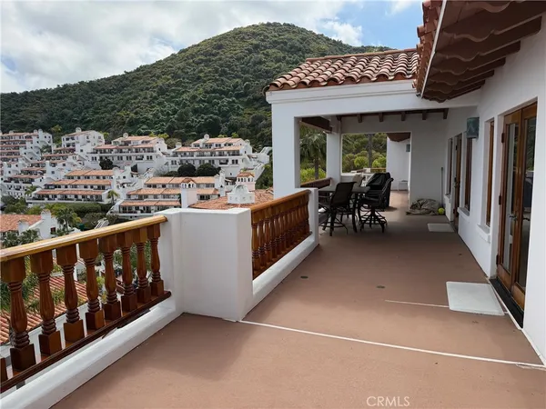 a view of a chairs and table in the balcony
