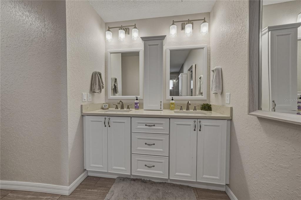 7435 Kilbride Court Weeki Wachee, FL 34613 - Photo 39 of 67 a bathroom with a granite countertop sink and a mirror
