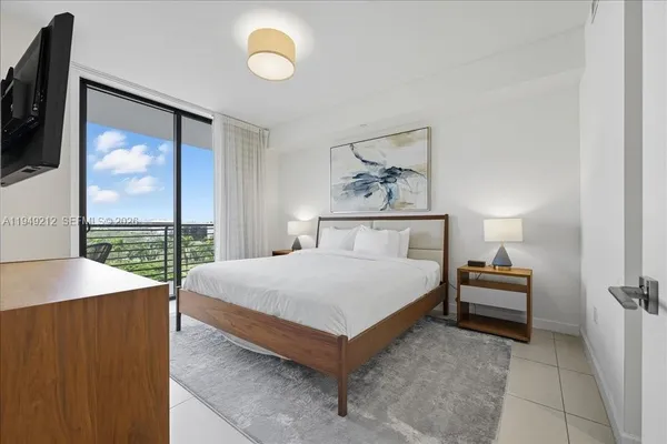 a bedroom with a bed and a painting on the wall