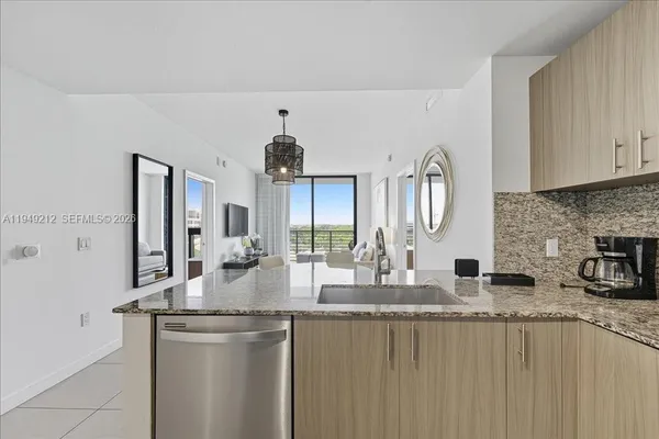 a kitchen with stainless steel appliances granite countertop a sink and cabinets