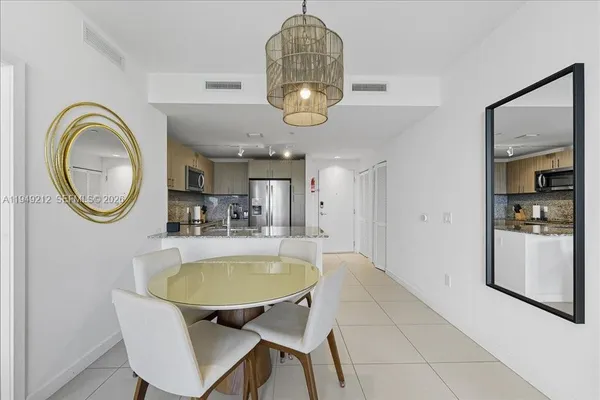 a dining room with furniture and a mirror