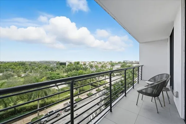 a view of two chairs in a balcony