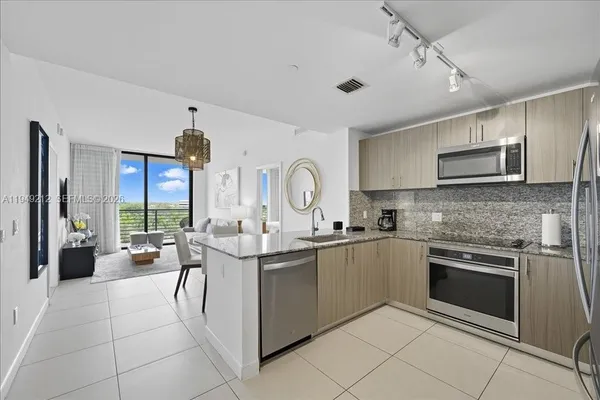 a kitchen with stainless steel appliances granite countertop a sink and cabinets