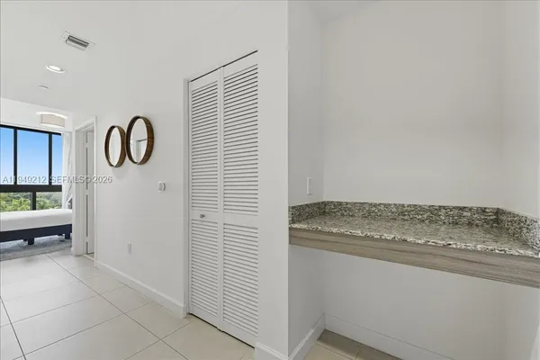 a utility room with cabinets washer and dryer