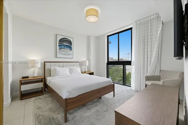 a bedroom with a bed and a window