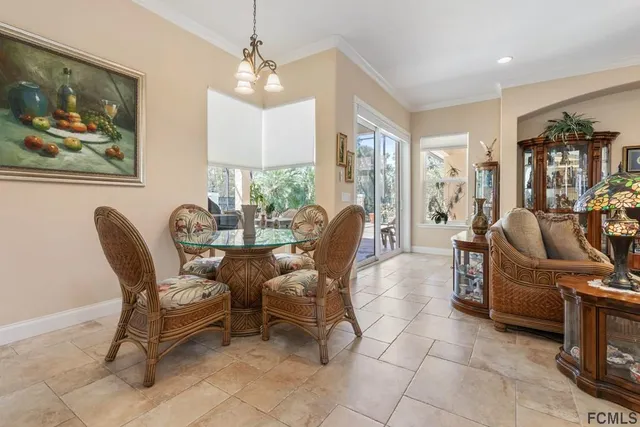 a dining room with furniture and natural light