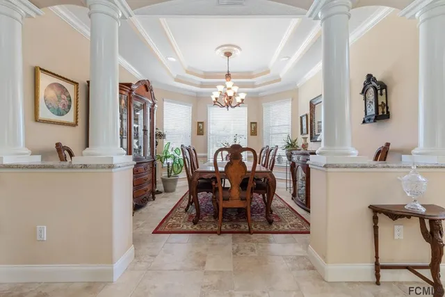 a view of a dining room with furniture and a chandelier