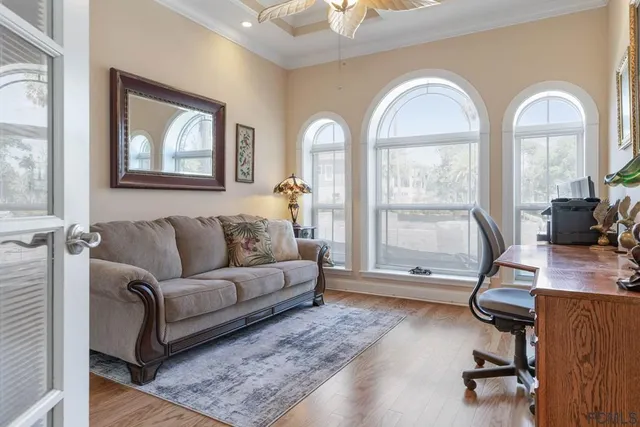 a living room with furniture and a wooden floor