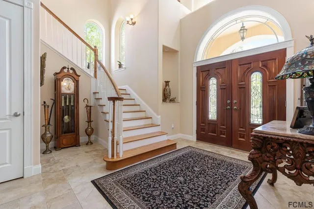 a view of a hallway with closet and mirrors