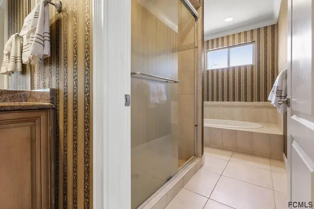 a white bath tub sitting next to a white toilet