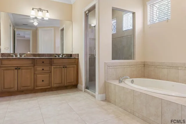 a bathroom with a tub shower and toilet
