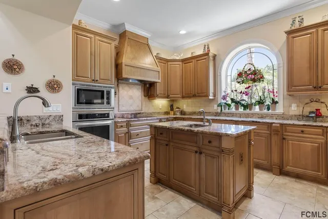 a kitchen with stainless steel appliances granite countertop a stove sink and cabinets