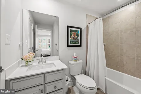 a bathroom with a sink toilet a mirror and shower