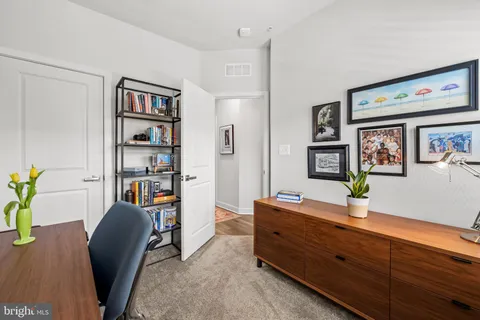 a living room with furniture and book shelf