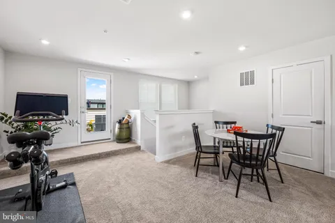 a view of a dining room with furniture and a window