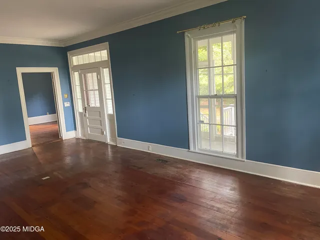 an empty room with wooden floor and closet