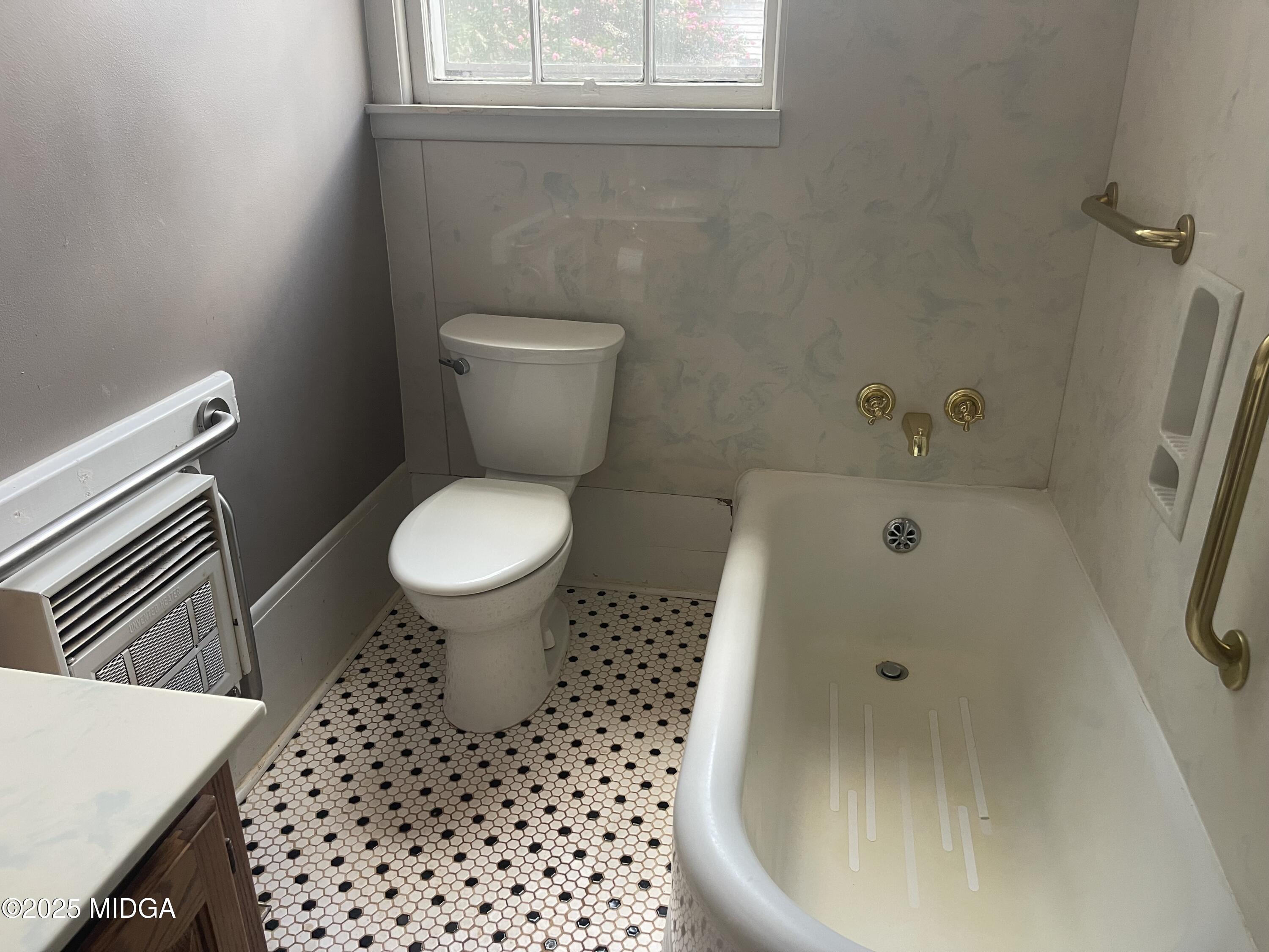 307 Woolfolk Road Fort Valley, GA 31030 - Photo 38 of 62 a bathroom with a toilet and a sink