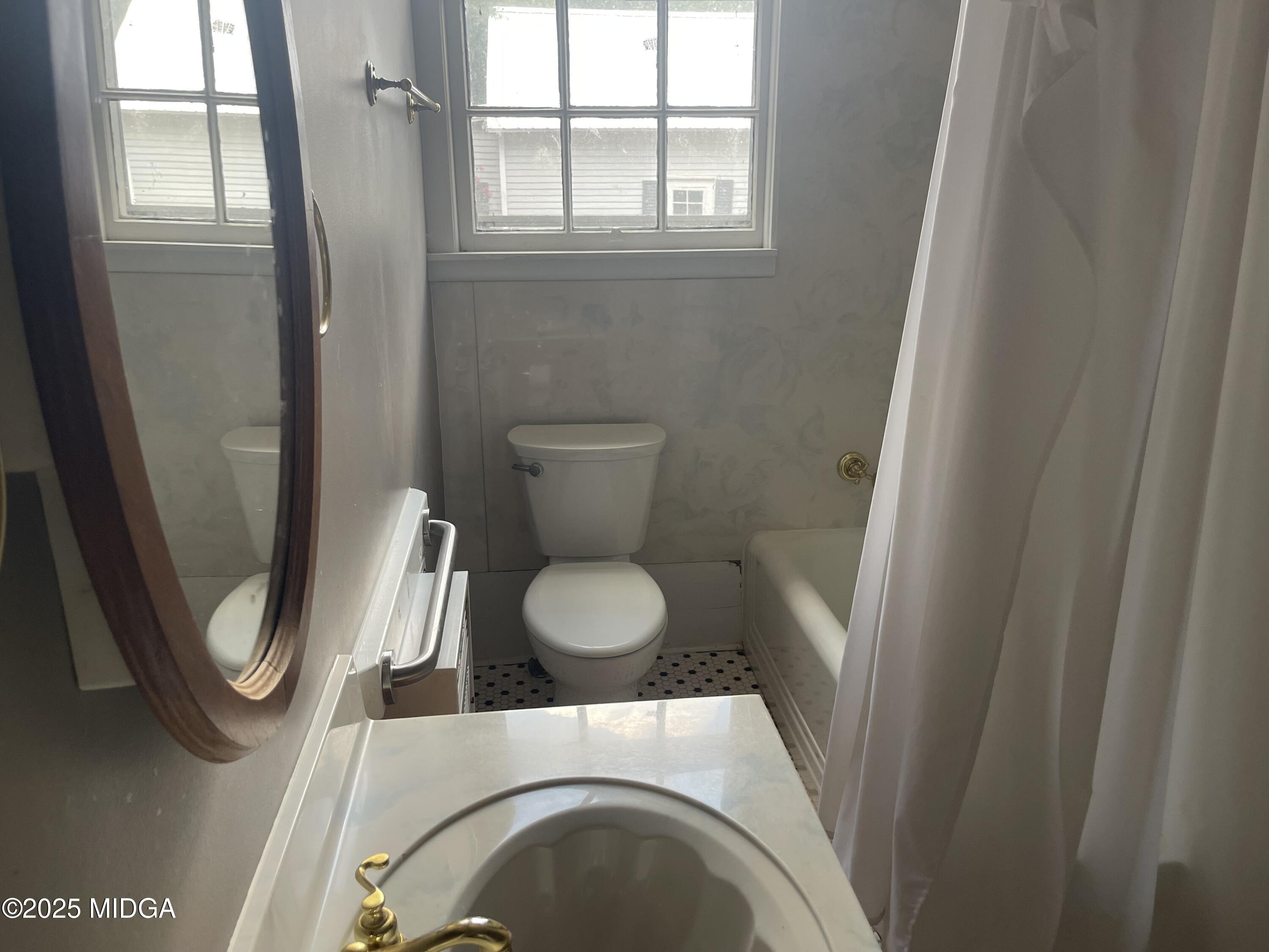 307 Woolfolk Road Fort Valley, GA 31030 - Photo 40 of 62 a bathroom with a toilet and a shower