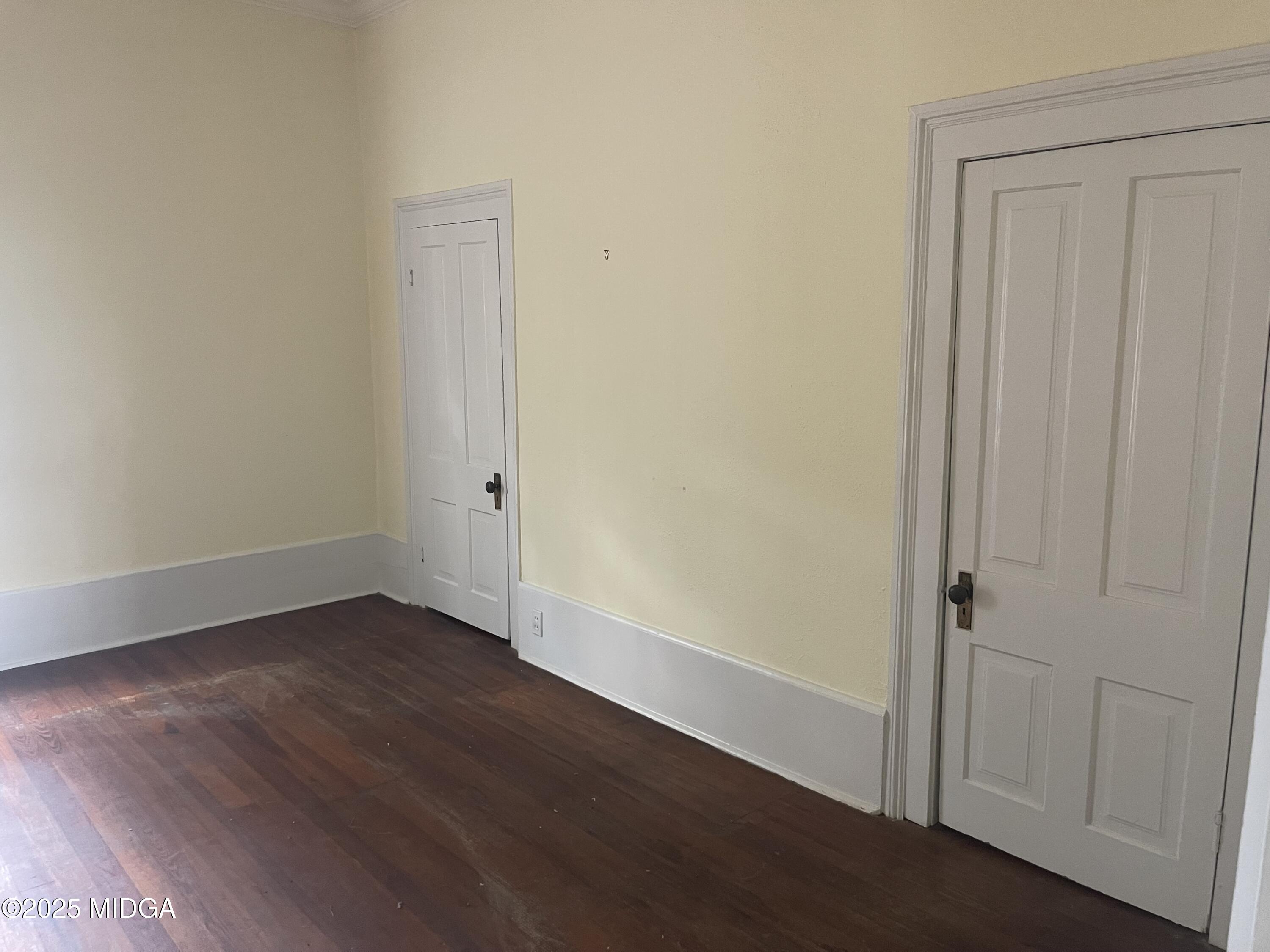 307 Woolfolk Road Fort Valley, GA 31030 - Photo 44 of 62 an empty room with wooden floor and closet