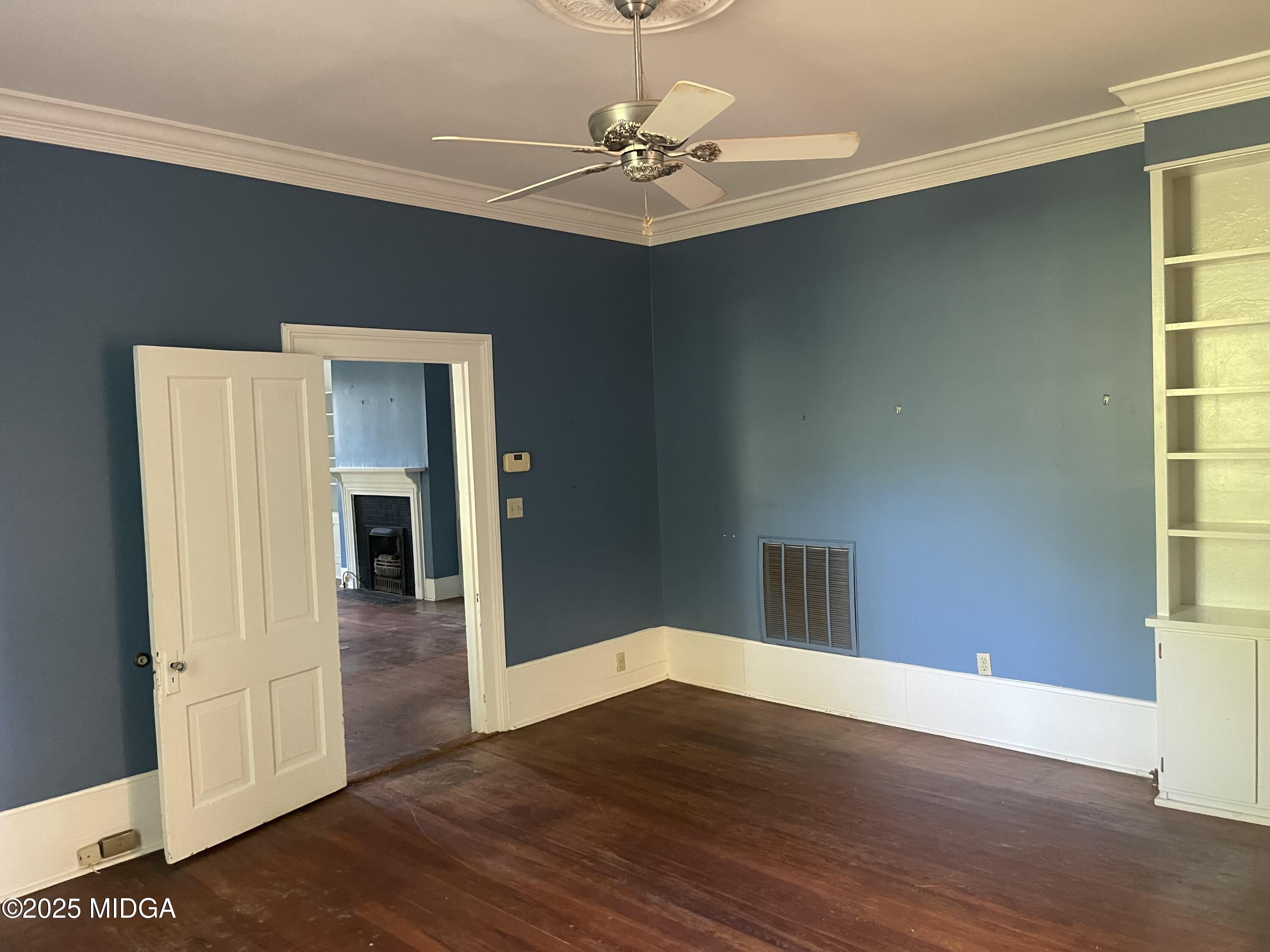 307 Woolfolk Road Fort Valley, GA 31030 - Photo 45 of 62 a view of a room with wooden floor and a ceiling fan