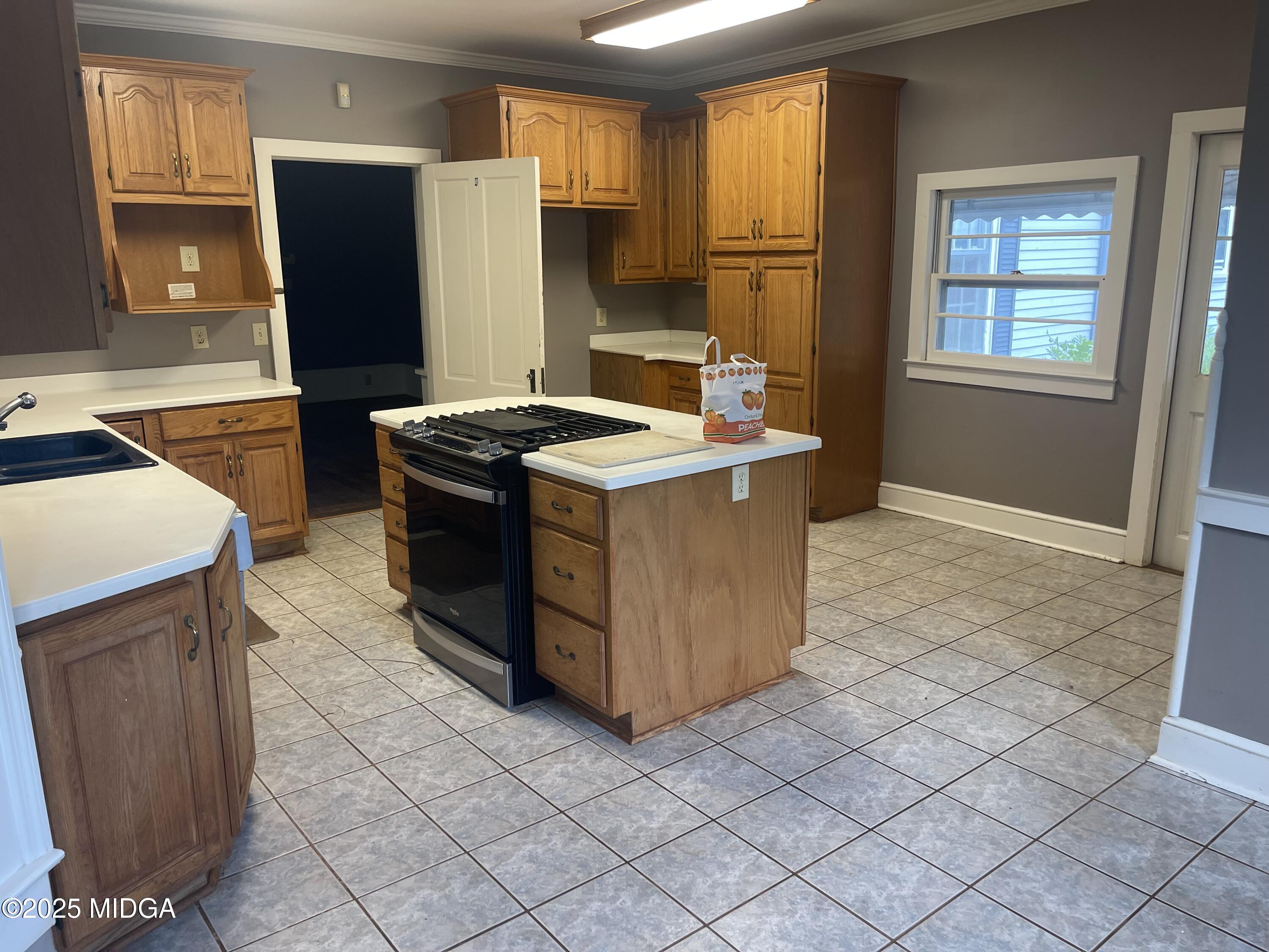 307 Woolfolk Road Fort Valley, GA 31030 - Photo 49 of 62 a kitchen with stainless steel appliances granite countertop a stove a refrigerator and a refrigerator