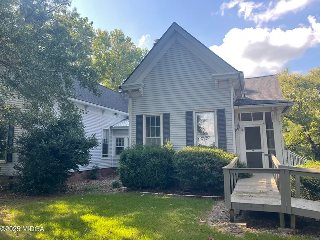 a house view with swimming pool in front of it