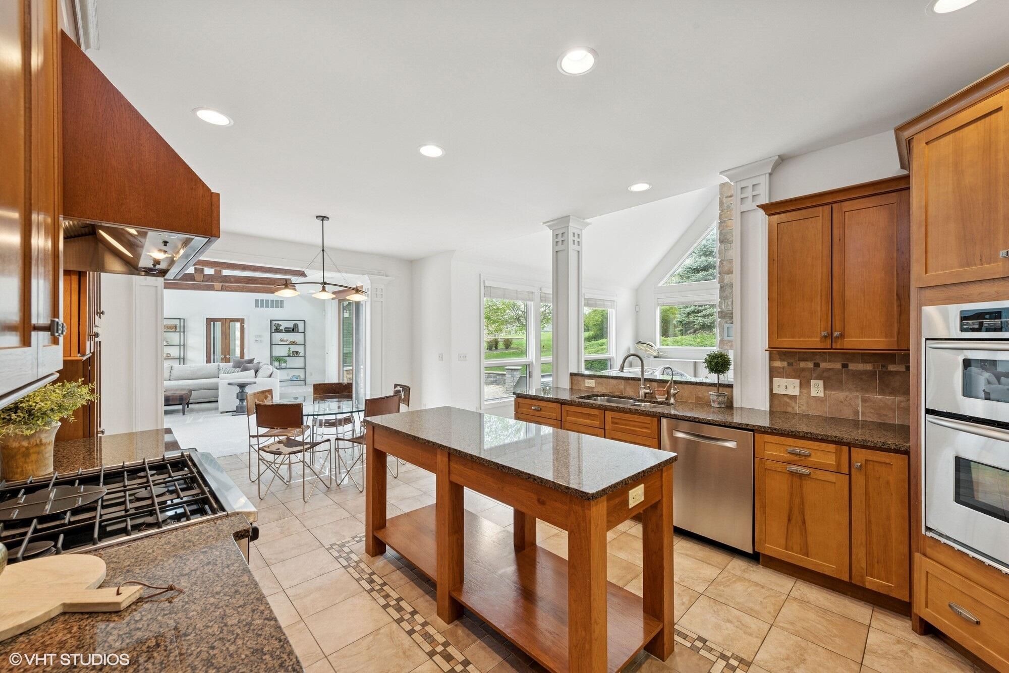 2252 Marrell Hill Road Valparaiso, IN 46385 - Photo 12 of 49 a kitchen with stainless steel appliances granite countertop a stove a sink and a refrigerator