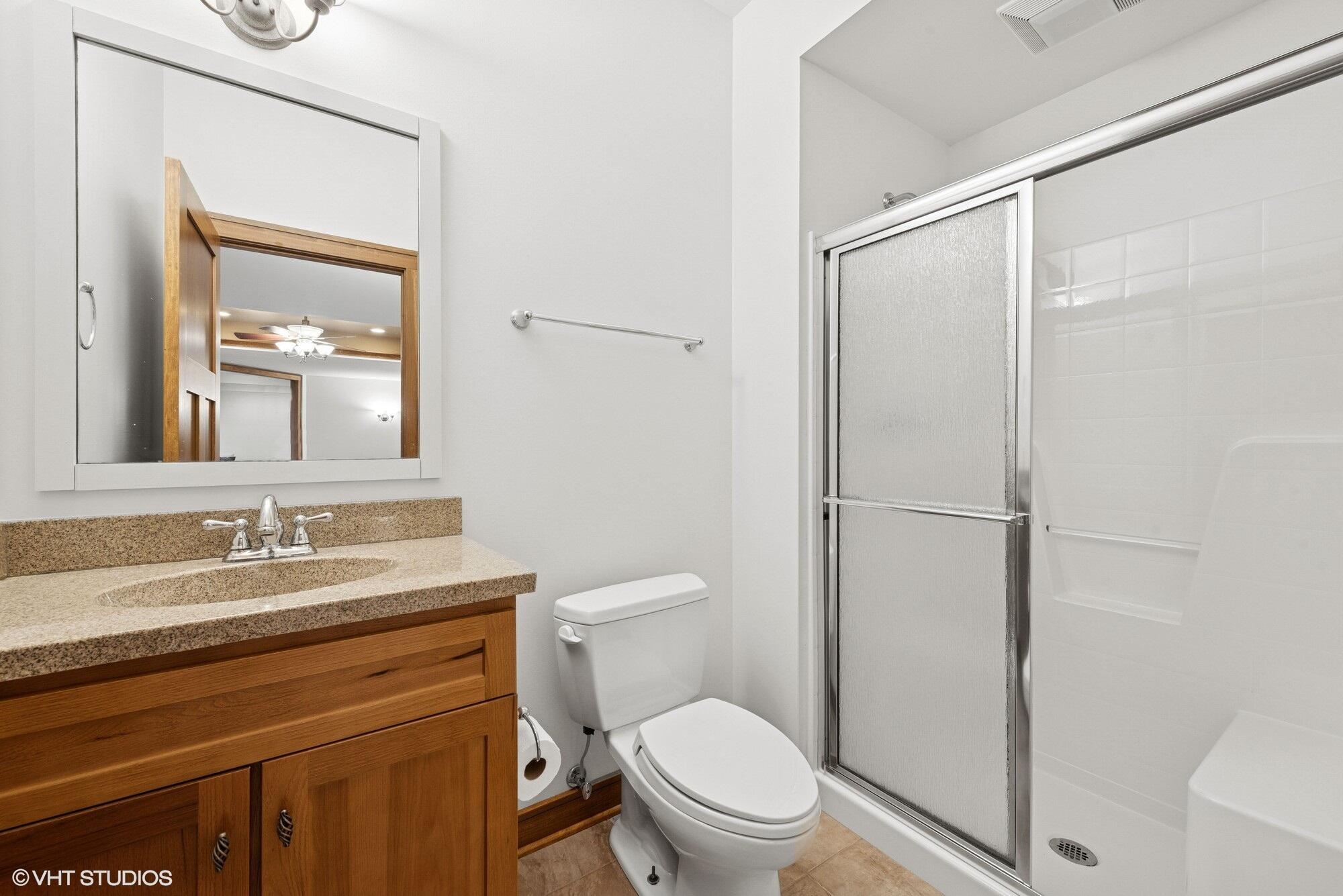 2252 Marrell Hill Road Valparaiso, IN 46385 - Photo 39 of 49 a bathroom with a sink a toilet a mirror and shower