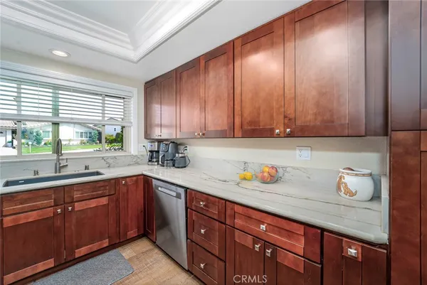 a kitchen with stainless steel appliances wooden cabinets and a sink