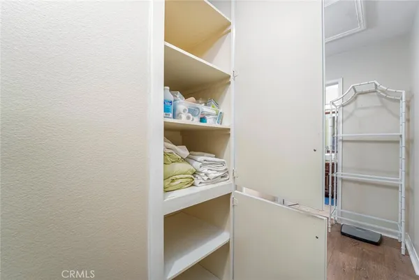 a bedroom with a bed and a dresser next to a window