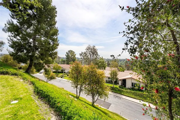 an aerial view of a house with garden space and street view