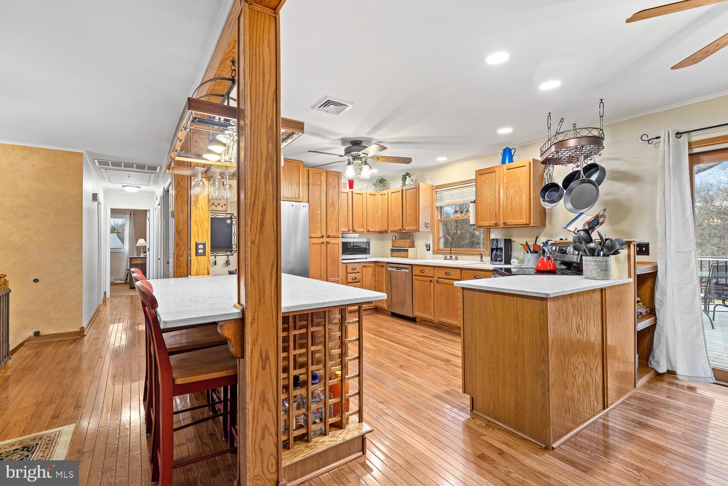 1573 Garrisonville Road Stafford, VA 22556 - Photo 10 of 63 a kitchen with stainless steel appliances kitchen island granite countertop a table chairs in it and wooden floors
