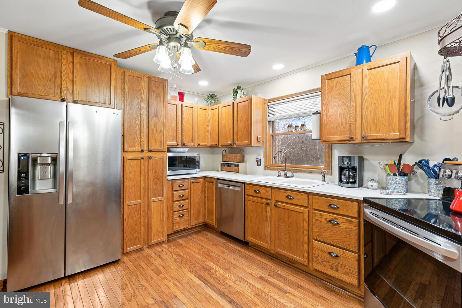 1573 Garrisonville Road Stafford, VA 22556 - Photo 11 of 63 a kitchen with a refrigerator a sink and cabinets
