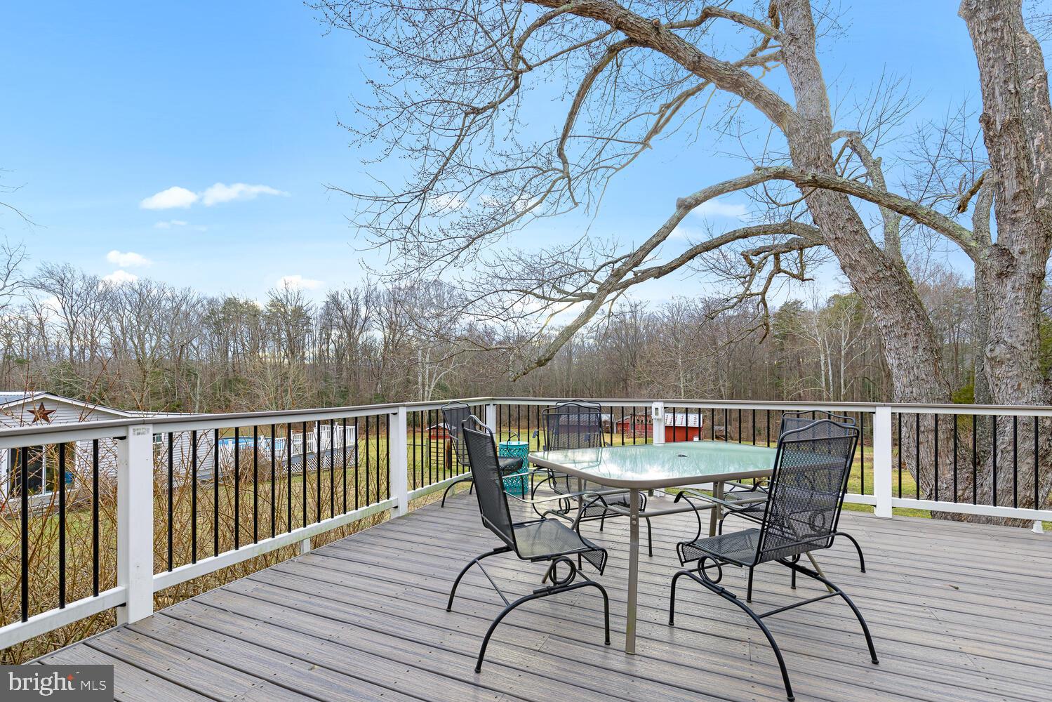 1573 Garrisonville Road Stafford, VA 22556 - Photo 29 of 63 a view of a roof deck with table and chairs and wooden floor
