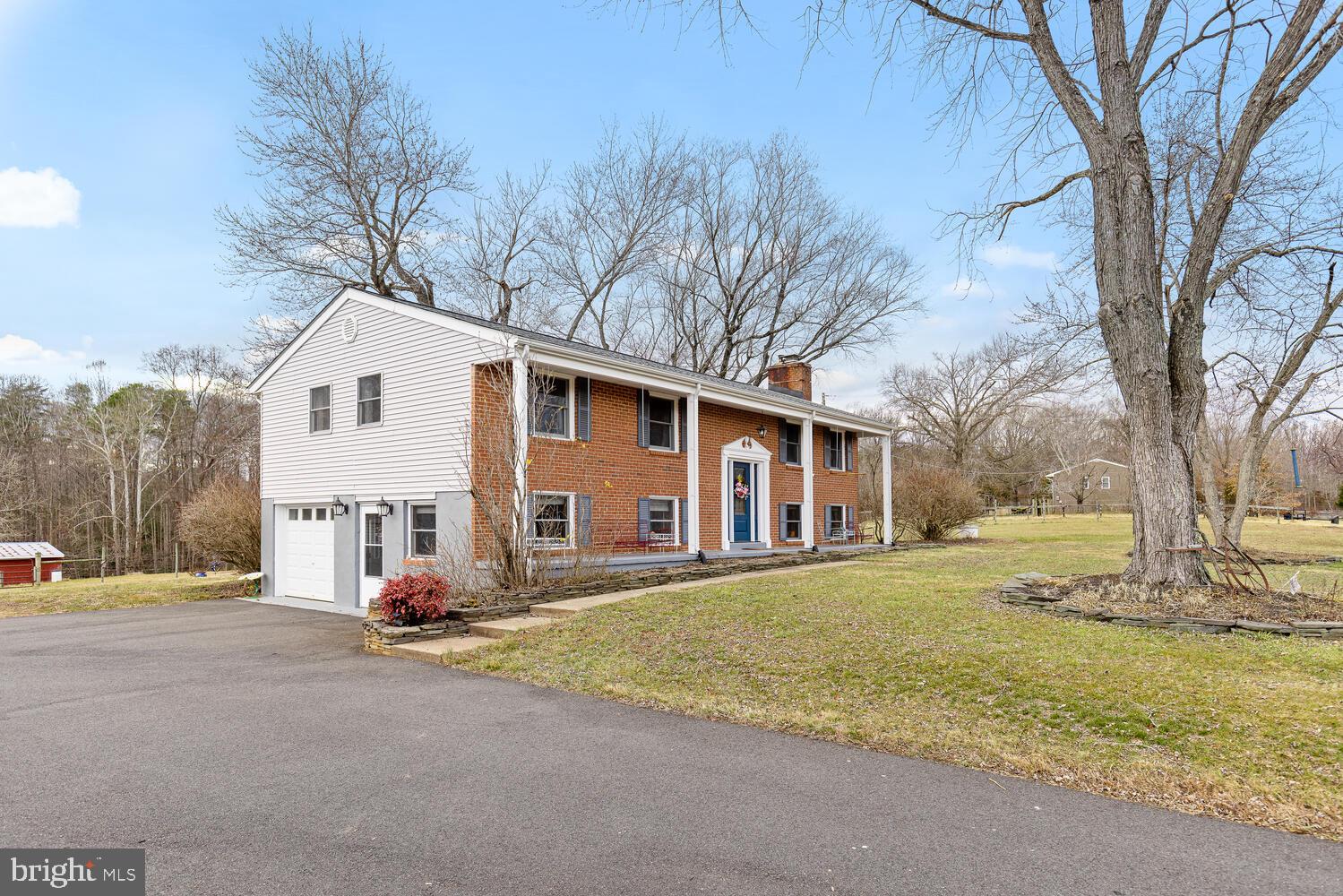 1573 Garrisonville Road Stafford, VA 22556 - Photo 40 of 63 a view of a house with a large tree in front of it