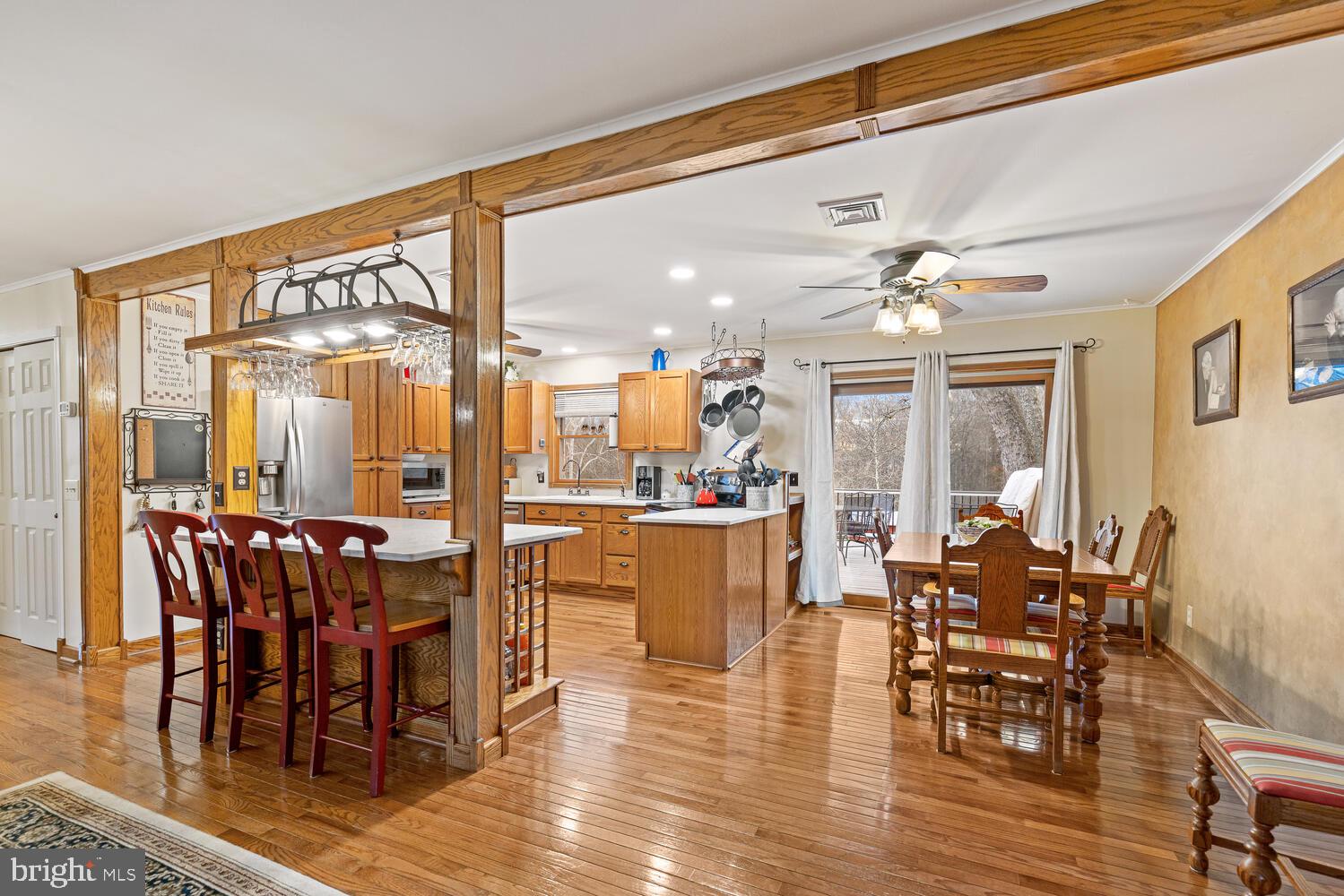 1573 Garrisonville Road Stafford, VA 22556 - Photo 63 of 63 a dining room with wooden floor a chandelier a glass table and chairs