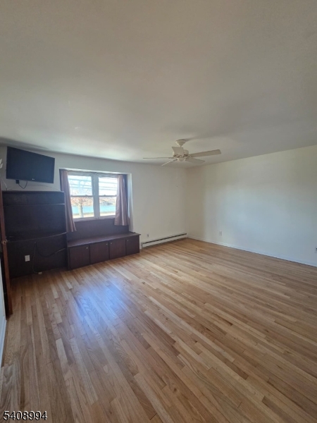 86 Bergen Turnpike, Unit A Ridgefield Park, NJ 07660 - Photo 12 of 14 an empty room with wooden floor and windows