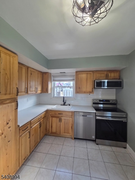 86 Bergen Turnpike, Unit A Ridgefield Park, NJ 07660 - Photo 7 of 14 a kitchen with stainless steel appliances granite countertop a sink and cabinets