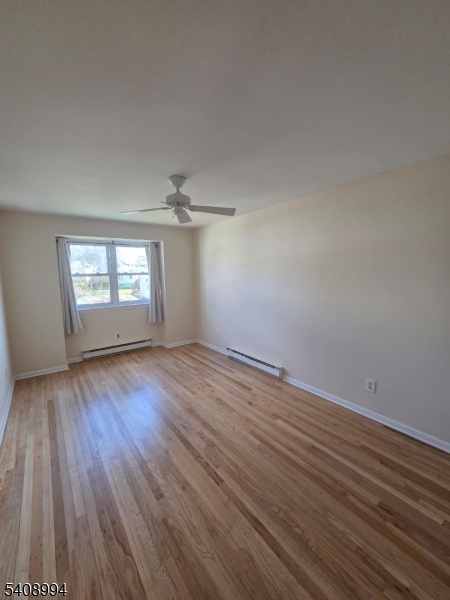 86 Bergen Turnpike, Unit A Ridgefield Park, NJ 07660 - Photo 10 of 14 an empty room with wooden floor and windows