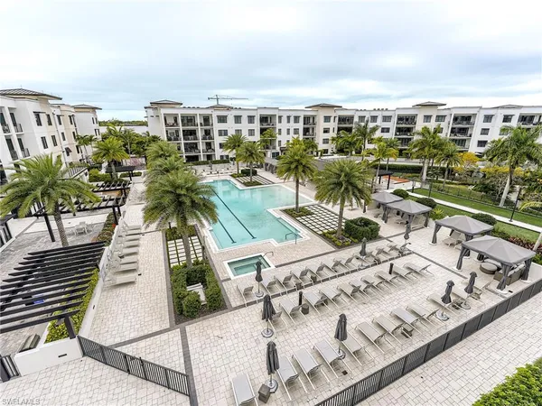 a dining room with furniture and a floor to ceiling window