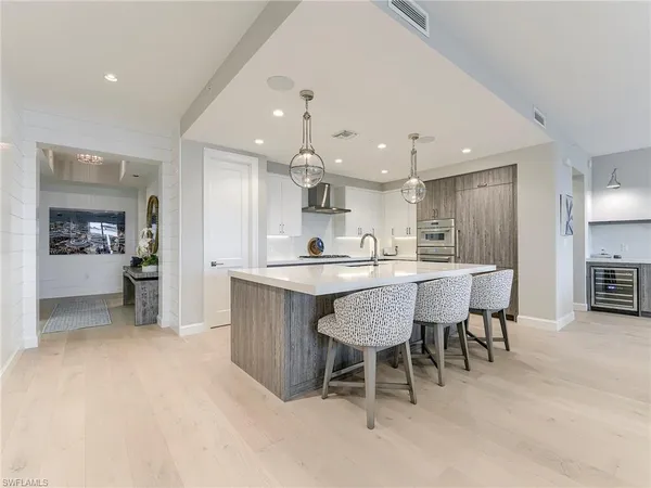 a kitchen with a dining table chairs and large window