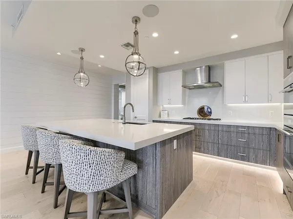 a kitchen with a table chairs and a refrigerator