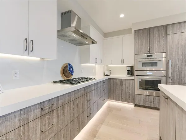 a kitchen with stainless steel appliances a sink and a stove