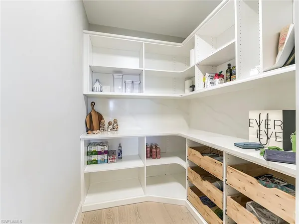 a view of storage and utility room with racks on the wall