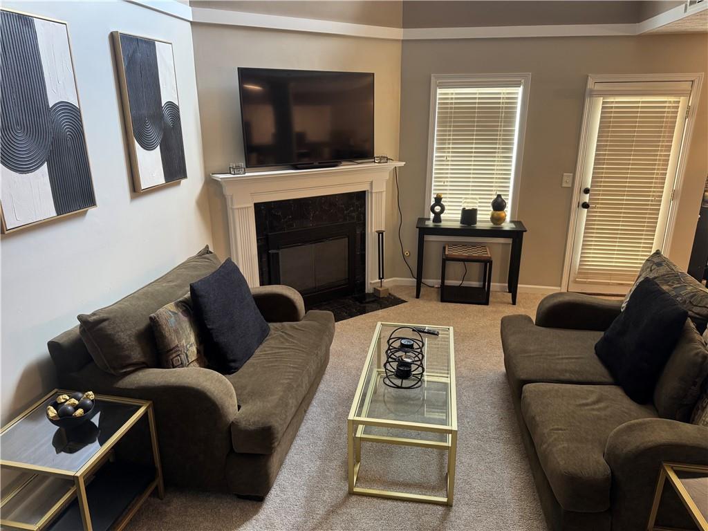 1922 Manhattan Parkway Decatur, GA 30035 - Photo 4 of 9 a living room with furniture a flat screen tv and a fireplace
